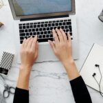 Email marketing hand with laptop laptop on desk